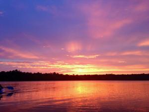 a sunset over a large body of water at Lakefront Tranquility Spacious Retreat Sleeps 14 in Grand Junction