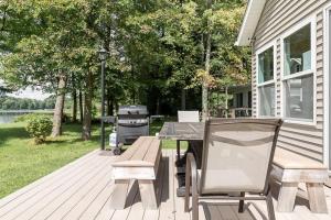 a picnic table and a grill on a patio at Lakefront Tranquility Spacious Retreat Sleeps 14 in Grand Junction +25 photos