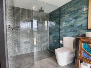 a bathroom with a toilet and a glass shower at Romantic Valley Cabin - Outdoor Bath in Glen Huon +15 photos