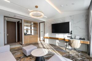 a room with a desk and a tv on a wall at Stanford hotel Andong in Andong
