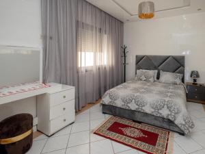 a bedroom with a bed and a dresser and a window at Vista bella luxurious apartment in Martil