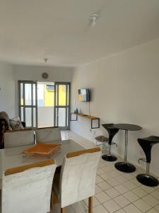 a living room with a table and chairs at Flat Barra Beach in Barra de São Miguel