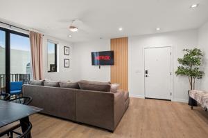a living room with a couch and a tv at King Bed EVCharger Sleeps 8 Balcony Laundry in San Diego