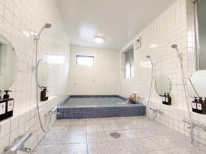 a bathroom with a tub with two mirrors at Eimiya Ryokan - Vacation STAY 36348v in Amakusa +13 photos