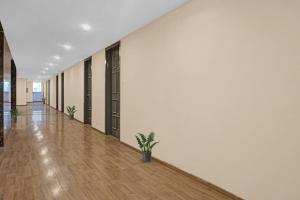 an empty hallway of an office building with potted plants at Townhouse Somani TC in Pune +63 photos