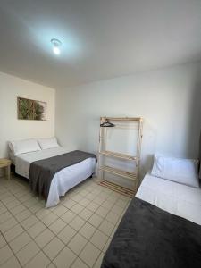 a bedroom with two beds in a room at Flat Barra Beach in Barra de São Miguel