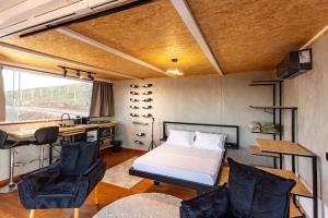 a bedroom with a bed and a desk and chairs at Cabana panorâmica in Cunha