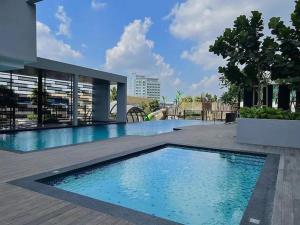 a large swimming pool in the middle of a building at Skytrees Bukit Indah by HCK Travelers Pause 2BR 1BA 3min in Johor Bahru