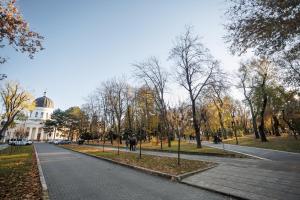 a street in a park with a building in the background at Dosoftei Residence in Chişinău