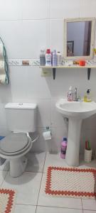 ein Badezimmer mit Toilette und Waschbecken in der Unterkunft Casa de veraneio in Caraguatatuba + 19 Fotos