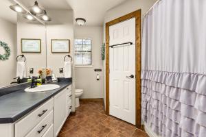 a bathroom with a sink and a toilet at the Hot Tub Farmhouse in Canyon Lake +30 photos