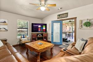 a living room with a couch and a coffee table at the Hot Tub Farmhouse in Canyon Lake