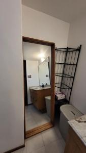 a bathroom with a sink and a toilet and a mirror at Hermosa Suite doble con baño privado in Mexico City