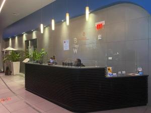 a counter in a restaurant with a person sitting at it at Beautiful Studio in Hallandale with Beach & Pool in Hallandale Beach