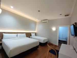 Postel nebo postele na pokoji v ubytování Hotel Bahtera PT.Pelni