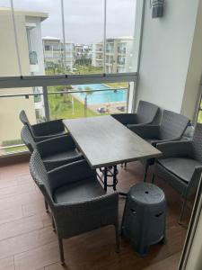 a table and chairs in a room with a view of the beach at À LOUER APPARTEMENT à Casabay in Sidi Rahal