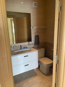 a bathroom with a sink and a toilet and a mirror at À LOUER APPARTEMENT à Casabay in Sidi Rahal
