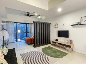 a living room with a television and a couch at The Cosmic - Icon City Petaling Jaya in Petaling Jaya