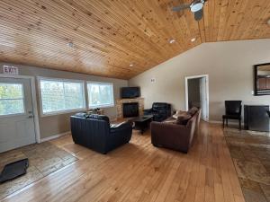 a living room with two couches and a wooden ceiling at Family & Pet Friendly Huron Getaway in Miller Lake