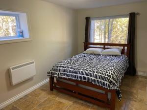a bed in a room with a window and a bed sidx sidx sidx at Family & Pet Friendly Huron Getaway in Miller Lake