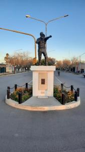 a statue of a man standing on top of a monument at Hospedaje "Crisbel" en Las Catitas in Las Catitas
