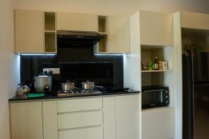 a kitchen with a stove and a microwave at Samadhi Lagoon Villa in Ratgama Hegoda +60 photos
