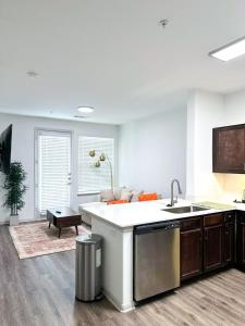 a kitchen with a sink and a counter top at The Frisco Upscale in Frisco
