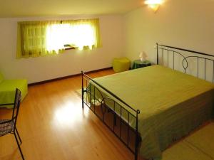 a bedroom with a bed and a chair and a window at Granite House by Tâmega with Pool in Luzim +33 photos