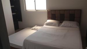 Voodi või voodid majutusasutuse Hotel Palmari toas