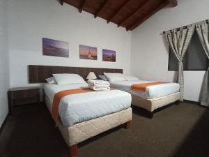 Postel nebo postele na pokoji v ubytování Hotel del Parque Confort LaCeja
