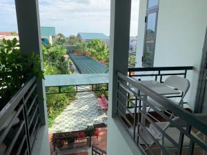 a balcony with a view of a garden at Nomad homestay in Ninh Hải