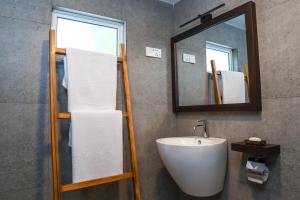 a bathroom with a sink and a mirror at Samadhi Lagoon Villa in Ratgama Hegoda