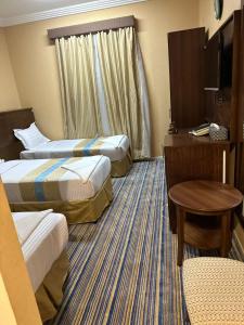 Postel nebo postele na pokoji v ubytování فندق نجمة ذاخر توصيل مجاني للحرم - Zakher Star Hotel Free Shuttle Service