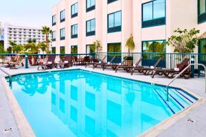 a swimming pool in front of a building at Best Western Plus Suites Hotel - Los Angeles LAX Airport in Inglewood