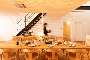 a dining room with a wooden table and chairs at Private luxury villa with ocean view Shodoshima in Shodoshima