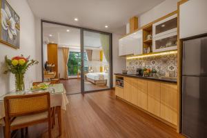 a kitchen with a table and a dining room at May Home Apartment Da Nang in Danang