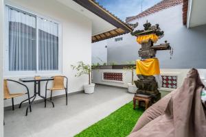 a balcony with a table and chairs in a house at Bali Bay by Urban Haven in Sanur +63 photos
