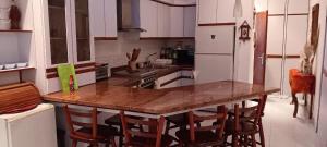 a kitchen with a wooden counter top and a refrigerator at residencias lalamar in Chichiriviche