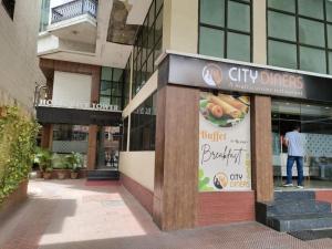 a man is standing outside of a restaurant at Hotel City Tower, Chennai Central in Chennai
