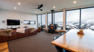 a living room with a couch and a table at Whitemount in Mount Hotham