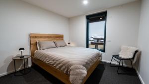 a bedroom with a large bed and a window at Whitemount in Mount Hotham