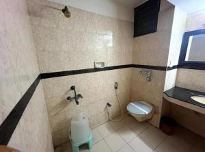 a bathroom with a toilet and a sink at Hotel City Tower, Chennai Central in Chennai +21 photos