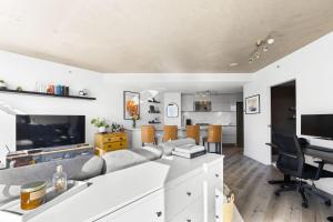 an open living room with a couch and a table at Luxury Central Apartment with City Views in Vancouver