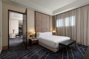 a hotel room with a bed and a mirror at Kimpton Margot Sydney by IHG in Sydney
