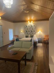 a living room with a bed and a couch at Munjoh Ocean Resort - Private Beachfront Luxury Retreat in Havelock in Havelock Island