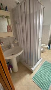 a bathroom with a shower and a sink at Casa Nando Relax e comfort home in Marina di Ascea +14 photos