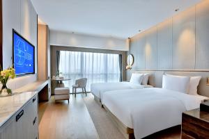 Postel nebo postele na pokoji v ubytování 银都酒店 Yandoo Hotel