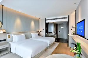 Postel nebo postele na pokoji v ubytování 银都酒店 Yandoo Hotel