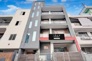 an apartment building with a sign in front of it at Super Collection O Sector 20 Noida in Noida