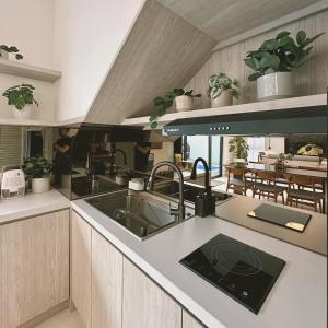 a kitchen with a sink and a counter top at Cerita di Villa - Your Second Home in Batu in Tlekung